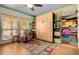 Bright bedroom with a murphy bed, shelving, chair, and colorful rug at 4444 W Chama Dr, Glendale, AZ 85310