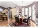 Elegant dining room with wood table, leather chairs, and bright windows with sheer curtains at 4444 W Chama Dr, Glendale, AZ 85310