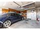 Spacious garage featuring a car, storage cabinets, and overhead storage at 4444 W Chama Dr, Glendale, AZ 85310