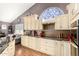 Kitchen features stainless appliances, white cabinetry and a decorative stain glass window at 4444 W Chama Dr, Glendale, AZ 85310