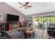 Spacious living room featuring hardwood floors, a ceiling fan, and large sliding glass doors at 4444 W Chama Dr, Glendale, AZ 85310