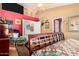 Bright main bedroom with decorative fan, colorful accents, wall-mounted television, and dark wood furniture at 4444 W Chama Dr, Glendale, AZ 85310