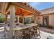 Outdoor kitchen and bar, with barstool seating offering a relaxing spot to unwind and enjoy outdoor living at 4444 W Chama Dr, Glendale, AZ 85310