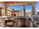 Outdoor kitchen with built-in appliances and stone accents, great for cooking and dining al fresco at 4444 W Chama Dr, Glendale, AZ 85310