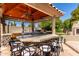 Inviting outdoor kitchen with stone bar, built-in grill, and seating perfect for backyard gatherings at 4444 W Chama Dr, Glendale, AZ 85310