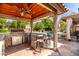 Well-equipped outdoor kitchen and bar offering great space for outdoor entertaining, with views of the pool at 4444 W Chama Dr, Glendale, AZ 85310