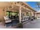 Stylish covered patio featuring comfortable seating, ceiling fans, and lush landscaping at 4444 W Chama Dr, Glendale, AZ 85310