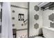 Modern shower with pebble floor, hexagon tile, built-in niche, and glass shower door at 4444 W Chama Dr, Glendale, AZ 85310