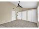 Spacious bedroom featuring neutral walls, carpet flooring, a ceiling fan, and ample closet space for storage at 4601 N 102Nd Ave # 1036, Phoenix, AZ 85037