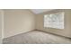 Bedroom featuring neutral walls, carpet flooring, and a window allowing natural light into the living space at 4601 N 102Nd Ave # 1036, Phoenix, AZ 85037