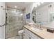 Well-lit bathroom with stone shower, stone floors, and custom vanity at 4800 N 68Th St # 109, Scottsdale, AZ 85251