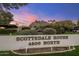 Scottsdale House 4800 North sign with mountain views and desert landscaping under a colorful evening sky at 4800 N 68Th St # 109, Scottsdale, AZ 85251