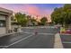 A gated community entrance with beautiful landscaping and caution signs under a colorful evening sky at 4800 N 68Th St # 109, Scottsdale, AZ 85251