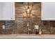 Elegant kitchen details with modern faucet, backsplash, and stylish overhead lighting at 4800 N 68Th St # 109, Scottsdale, AZ 85251