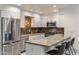 Modern kitchen featuring stainless steel appliances, granite countertops, and stylish pendant lighting at 4800 N 68Th St # 109, Scottsdale, AZ 85251