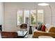 Bright living room featuring white brick, natural light, and modern furnishings at 4800 N 68Th St # 109, Scottsdale, AZ 85251