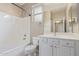 Neat bathroom featuring a bathtub, toilet, and a vanity with ample storage and a framed mirror at 4806 E Thunderbird Dr, Chandler, AZ 85249