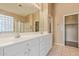 Bright bathroom featuring dual sinks, a glass block window, and a separate glass shower, enhancing the spa-like feel at 4806 E Thunderbird Dr, Chandler, AZ 85249