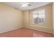 A simple bedroom with laminate floors, a ceiling fan, and a window with blinds for natural light control at 4806 E Thunderbird Dr, Chandler, AZ 85249