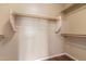 A well-organized walk-in closet offering ample storage with sturdy wooden rods and shelving for clothing and accessories at 4806 E Thunderbird Dr, Chandler, AZ 85249