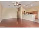 Spacious living room featuring laminate floors, a ceiling fan, neutral paint, and an open-concept layout to the kitchen at 4806 E Thunderbird Dr, Chandler, AZ 85249