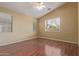 Bright main bedroom with laminate floors, neutral paint, ceiling fan, and generous windows offering plenty of natural light at 4806 E Thunderbird Dr, Chandler, AZ 85249