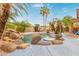 Beautiful pool features an artful rock waterfall, small table, and lush tropical landscaping to complete the outdoor oasis at 4806 E Thunderbird Dr, Chandler, AZ 85249