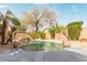 Inviting backyard pool offers a relaxing waterfall feature and basketball hoop for outdoor fun and entertainment at 4806 E Thunderbird Dr, Chandler, AZ 85249