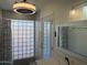 Bathroom with a glass block window, mosaic tiles, and stylish fixtures at 4807 E Everett Dr, Scottsdale, AZ 85254