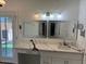 Modern bathroom features double mirrors, vanity, and stylish black veined countertops at 4807 E Everett Dr, Scottsdale, AZ 85254