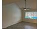 Bright bedroom featuring tile flooring, a ceiling fan, and a window overlooking the pool at 4807 E Everett Dr, Scottsdale, AZ 85254