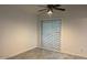 Bedroom features tile floors, a ceiling fan, and a window with blinds for natural light at 4807 E Everett Dr, Scottsdale, AZ 85254