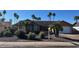 Well-maintained single-story home with desert landscaping and a two-car garage, complemented by mature palm trees at 4807 E Everett Dr, Scottsdale, AZ 85254