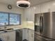 Bright kitchen showcasing white cabinets, stainless steel appliances, stylish lighting and modern countertops at 4807 E Everett Dr, Scottsdale, AZ 85254