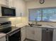 Updated kitchen featuring white cabinets, a stainless steel microwave, and stunning countertops at 4807 E Everett Dr, Scottsdale, AZ 85254