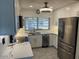 Modern kitchen with white cabinets, stainless steel appliances, and elegant countertops, illuminated by stylish lighting at 4807 E Everett Dr, Scottsdale, AZ 85254