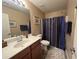 Bathroom featuring single sink with wood cabinets and a walk in shower at 4939 W Harwell Rd, Laveen, AZ 85339