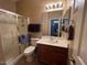 Bathroom featuring a glass door shower and a sink with light wood cabinets at 4939 W Harwell Rd, Laveen, AZ 85339