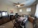 Bedroom with neutral colored walls, ceiling fan, and desk area at 4939 W Harwell Rd, Laveen, AZ 85339