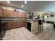 Well-lit kitchen with granite countertops, tile flooring, and dark appliances at 4939 W Harwell Rd, Laveen, AZ 85339