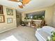 Cozy living room features a ceiling fan, interior window, and neutral colored walls at 4939 W Harwell Rd, Laveen, AZ 85339