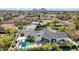 An aerial view of the home's backyard and a large outdoor seating area, pool and a lush green lawn at 6114 E Calle Del Norte --, Scottsdale, AZ 85251