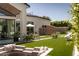 Inviting backyard featuring a modern patio with plush seating, lush lawn, and stylish landscaping at 6114 E Calle Del Norte --, Scottsdale, AZ 85251