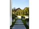 Beautiful walkway, artificial turf, modern planters, and mature trees offering great backyard curb appeal at 6114 E Calle Del Norte --, Scottsdale, AZ 85251