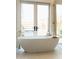 Freestanding bathtub with gold fixtures and natural light at 6114 E Calle Del Norte --, Scottsdale, AZ 85251