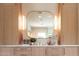 A bathroom with a light wood vanity, marble counter, and rounded mirror at 6114 E Calle Del Norte --, Scottsdale, AZ 85251