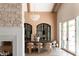 Dining room with a decorative light fixture, stone wall, and modern furnishings at 6114 E Calle Del Norte --, Scottsdale, AZ 85251