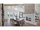 Bright dining room featuring a stone fireplace, chandelier lighting, and french doors to the front yard at 6114 E Calle Del Norte --, Scottsdale, AZ 85251