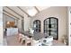 Dining room with high ceilings and wood beams with view of kitchen and custom shelving unit at 6114 E Calle Del Norte --, Scottsdale, AZ 85251