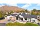 A long exterior view showing the home featuring a well-manicured lawn and a three-car garage at 6114 E Calle Del Norte --, Scottsdale, AZ 85251